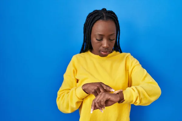Beautiful Black Woman Standing Blue Background Checking Time Wrist Watch — Stockfoto