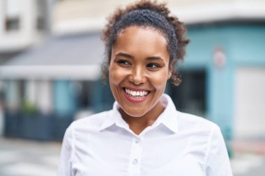 African american woman smiling confident looking to the side at street