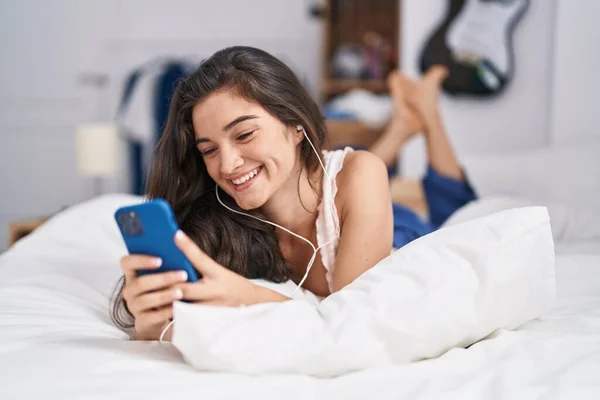 Young Hispanic Woman Listening Music Lying Bed Bedroom — Stockfoto