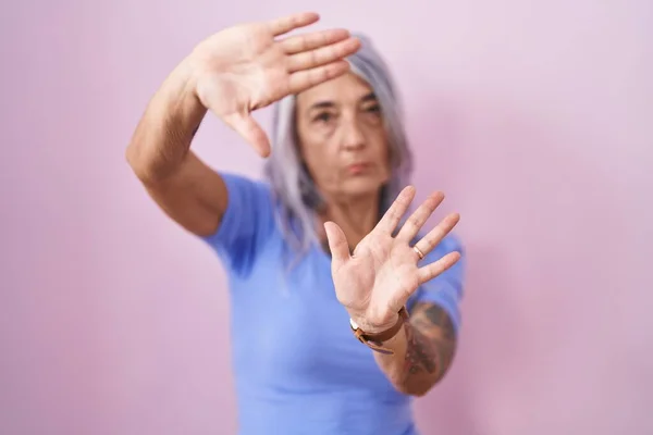 Жінка Середнього Віку Татуюваннями Стоять Над Рожевим Тлом Робить Рамку — стокове фото