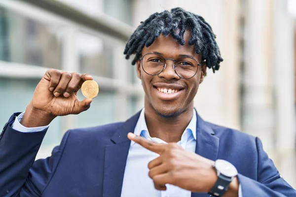 若いですアフリカの男とともにDrellocks保持仮想通貨ビットコイン笑顔幸せなポインティングとともに手と指 — ストック写真