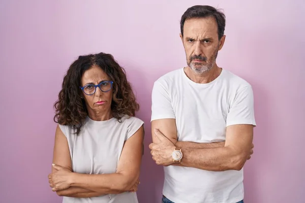 Middle Age Hispanic Couple Together Pink Background Skeptic Nervous Disapproving — Stock Fotó