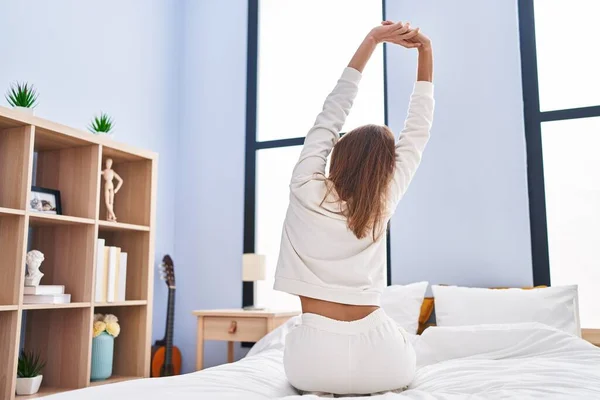 Young Woman Stretching Arms Sitting Bed Bedroom — Stockfoto