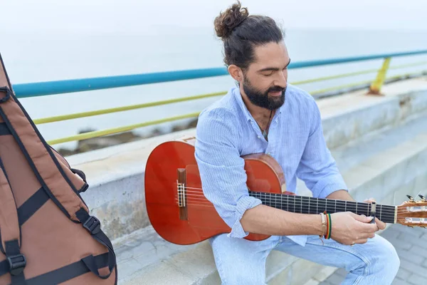 Young Hispanic Man Musician Playing Classical Guitar Sitting Bench Seaside —  Fotos de Stock