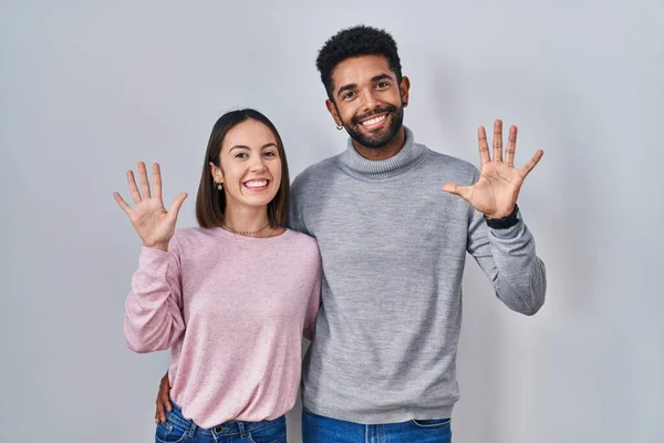 Young Hispanic Couple Standing Together Showing Pointing Fingers Number Ten — Stock Photo, Image