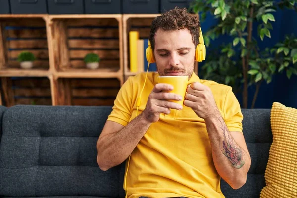 Young Hispanic Man Listening Music Drinking Coffee Home — Zdjęcie stockowe