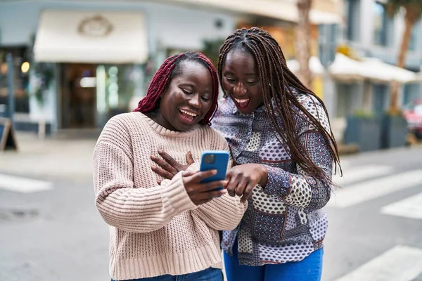 African American Women Friends Smiling Confident Using Smartphone Street — ストック写真