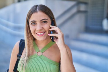 Young beautiful hispanic woman smiling confident talking on the smartphone at university