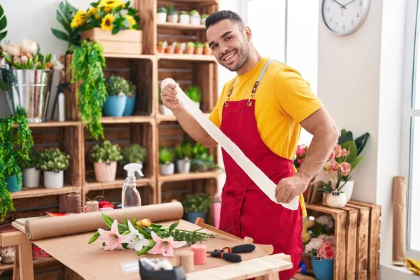 stock image Young hispanic man florist smiling confident holding gift lace at florist