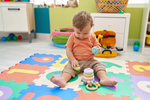 Adorable Blond Toddler Playing Hoops Toy Sitting Floor Kindergarten — Fotografia de Stock
