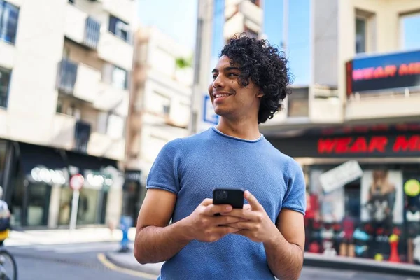Junger Hispanischer Mann Lächelt Selbstbewusst Mit Smartphone Auf Der Straße — Stockfoto