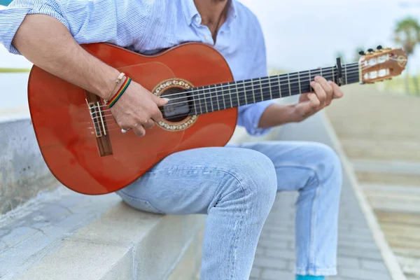 Young Hispanic Man Musician Playing Classical Guitar Sitting Bench Seaside Royalty Free Stock Images