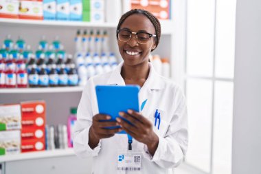 Eczanede çalışan Afrikalı Amerikalı kadın eczacı.