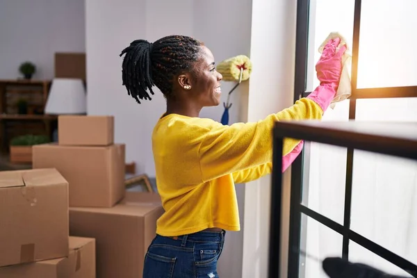 African American Woman Smiling Confident Cleaning Window New Home — Stockfoto