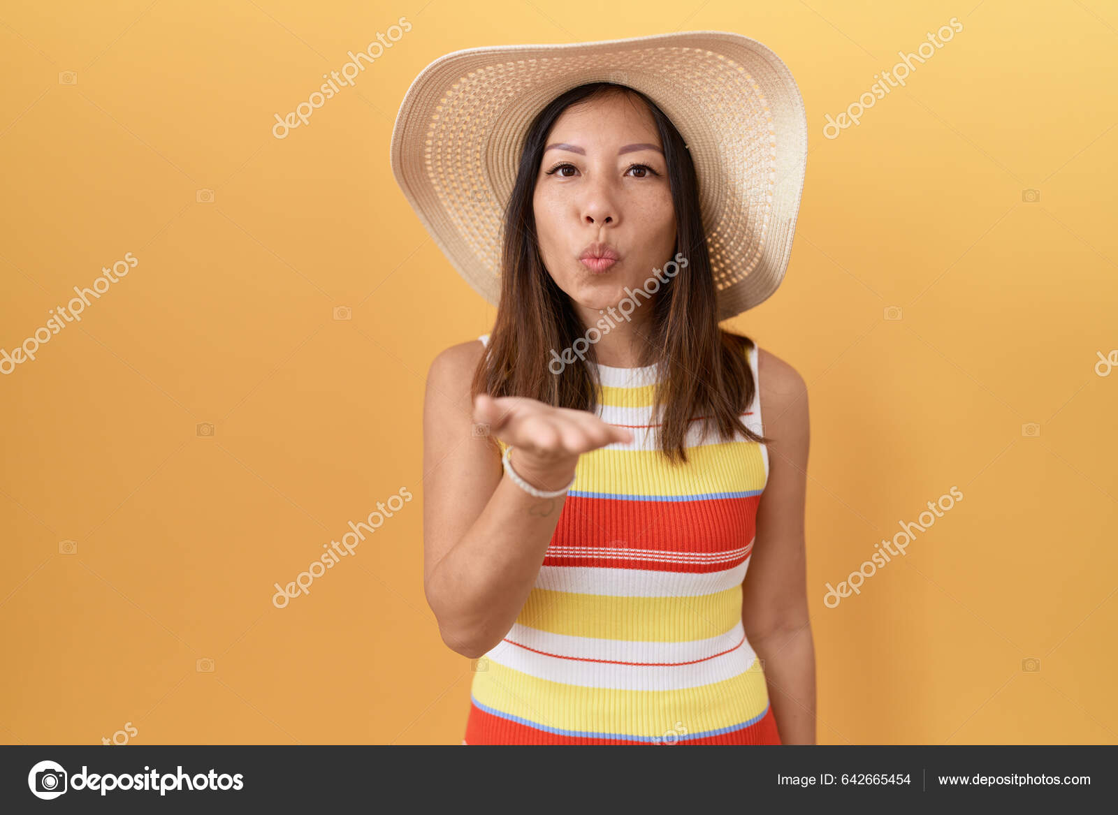 Middle Age Chinese Woman Wearing Summer Hat Yellow Background