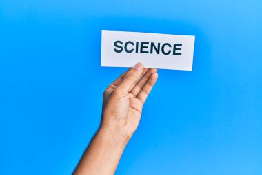 Hand of caucasian man holding paper with science word over isolated blue background