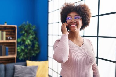 African american woman smiling confident talking on smartphone at home