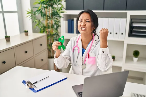 Young Asian Doctor Woman Holding Support Green Ribbon Annoyed Frustrated — ストック写真