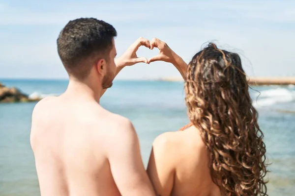 Young Hispanic Couple Tourists Wearing Swimsuit Doing Heart Gesture Hands — Stock Photo, Image