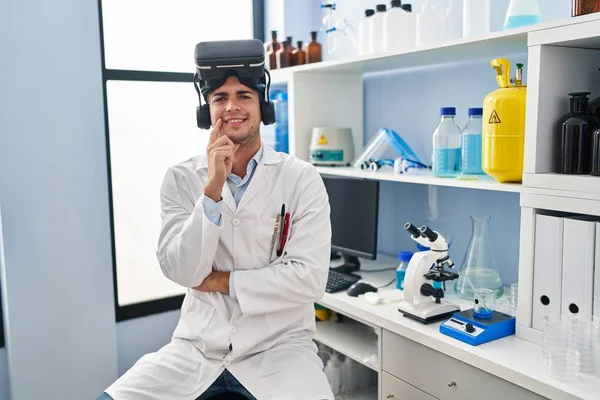 Young Hispanic Man Working Scientist Laboratory Wearing Glasses Smiling Looking — Stock Photo, Image