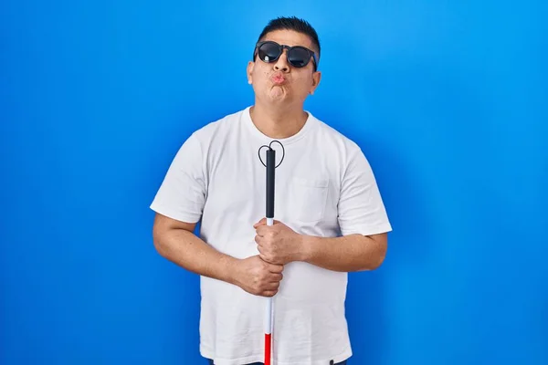 Hispanic Young Blind Man Holding Cane Looking Camera Blowing Kiss — Zdjęcie stockowe