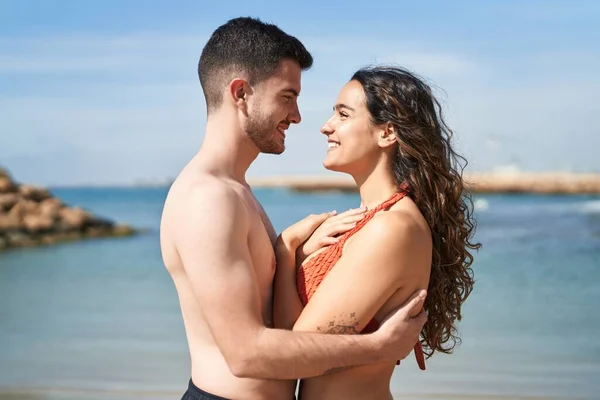 Young Hispanic Couple Tourists Wearing Swimsuit Hugging Each Other Seaside — 스톡 사진