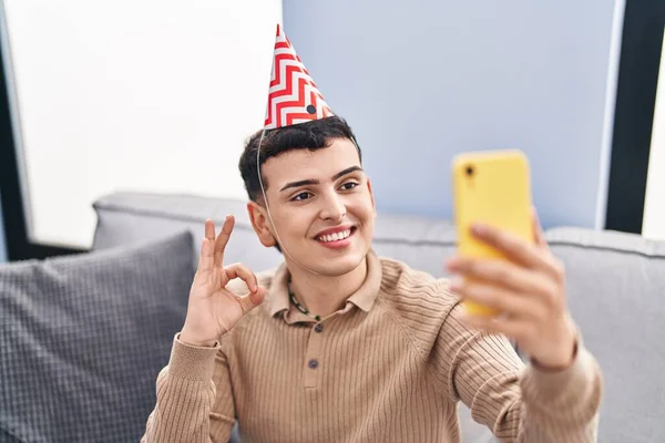 Non binary person celebrating birthday doing video call doing ok sign with fingers, smiling friendly gesturing excellent symbol