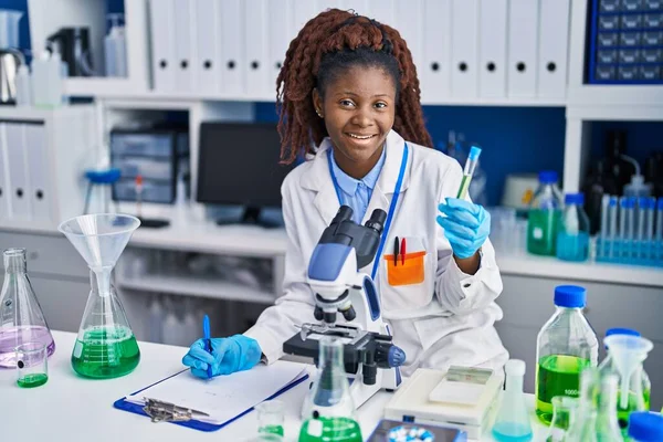 African American Woman Scientist Holding Test Tube Writing Report Laboratory — Stock Photo, Image