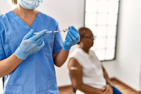 アフリカ系アメリカ人のシニア女性患者がクリニックで予防接種を受け — ストック写真