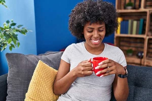 African American Woman Drinking Coffee Sitting Sofa Home — стокове фото