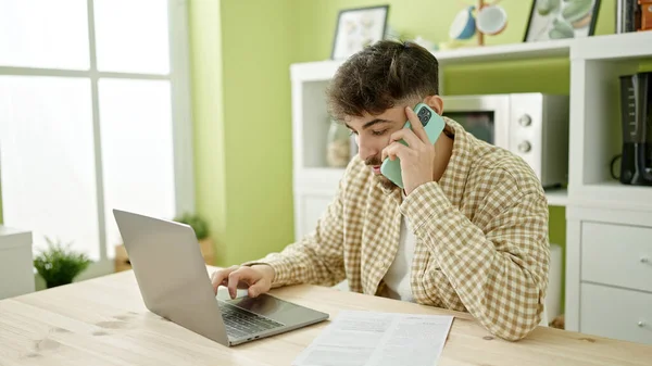 Hombre Árabe Joven Usando Ordenador Portátil Hablando Teléfono Inteligente Casa — Foto de Stock