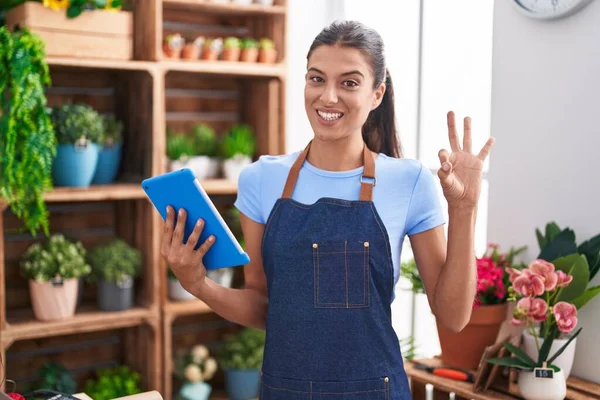 Brunette Young Woman Working Florist Shop Holding Tablet Doing Sign — Stock Photo, Image