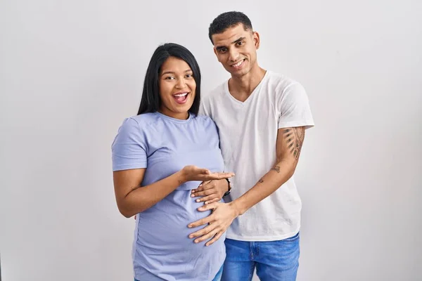 Young Hispanic Couple Expecting Baby Standing Background Pointing Aside Hands — Stock Photo, Image