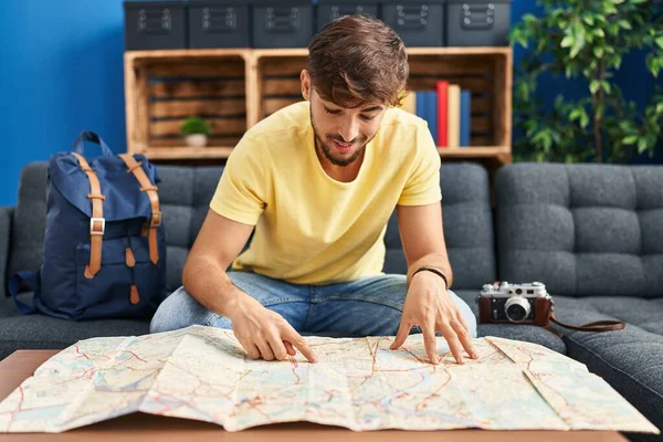 Young Arab Man Looking City Map Sitting Sofa Home — Stockfoto
