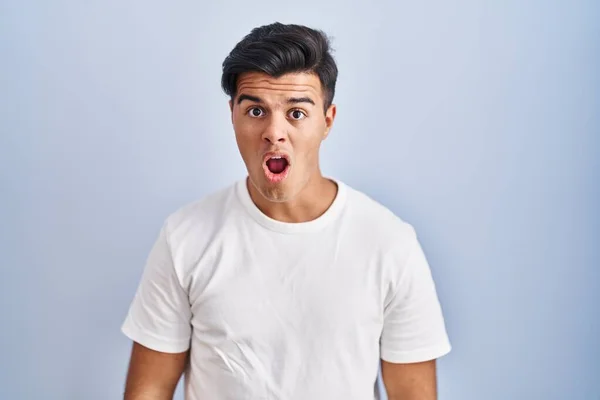 Hispanic Man Standing Blue Background Shock Face Looking Skeptical Sarcastic — 图库照片