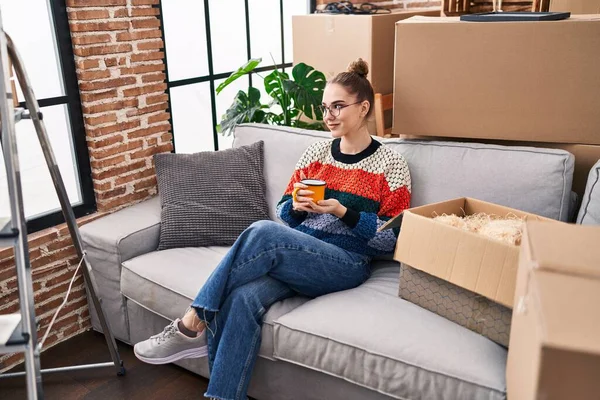 Young Woman Drinking Coffee Sitting Sofa New Home — Foto Stock