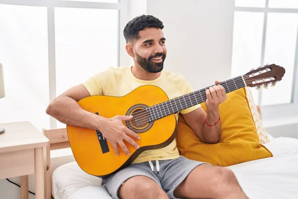 Young Arab Man Playing Classical Guitar Sitting Bed Bedroom — Fotografia de Stock