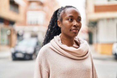African american woman standing with doubt expression at street