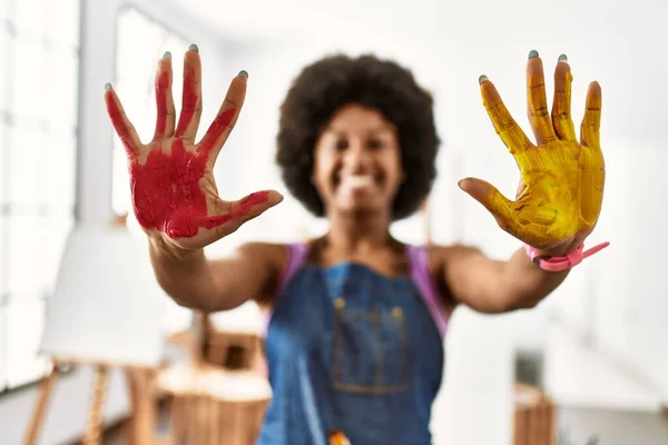 年轻的非洲裔美国女人微笑着 自信地在艺术工作室展示手绘手绘 — 图库照片