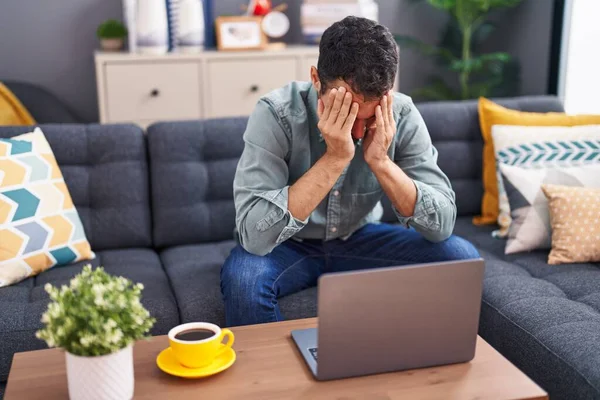 Young Hispanic Man Stressed Using Laptop Sitting Sofa Home — Stock Photo, Image