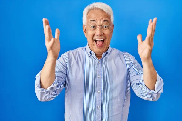 Hispanic Senior Man Wearing Glasses Celebrating Crazy Amazed Success Arms — Stock Photo, Image