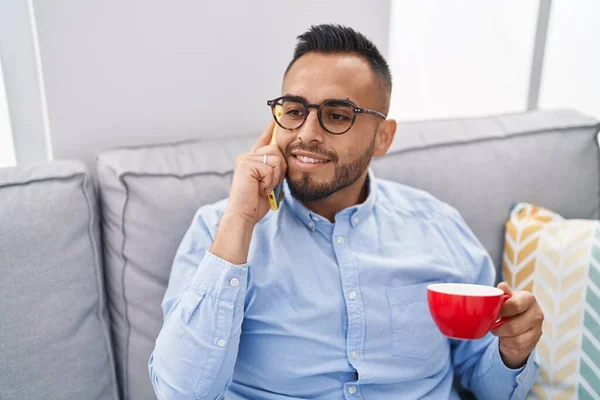 Jonge Spaanse Man Die Koffie Drinkt Thuis Smartphone Praat — Stockfoto