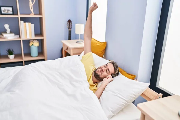 Young Man Waking Stretching Arms Bedroom — Stockfoto
