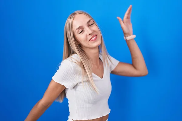 Young Caucasian Woman Standing Blue Background Dancing Happy Cheerful Smiling — Foto de Stock