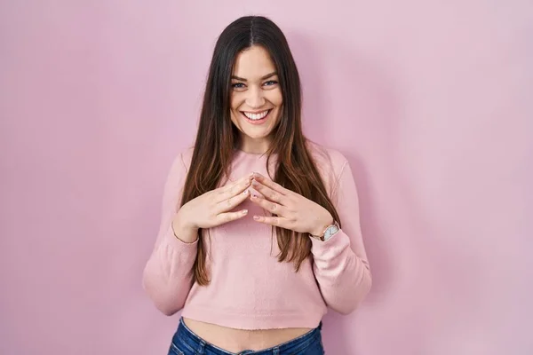 Young Brunette Woman Standing Pink Background Hands Together Fingers Crossed — Stockfoto