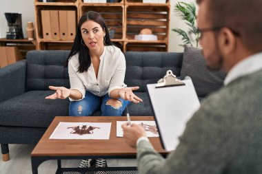 Man and woman psychology and patient doing rorschach test having psychologist session at psychology clinic