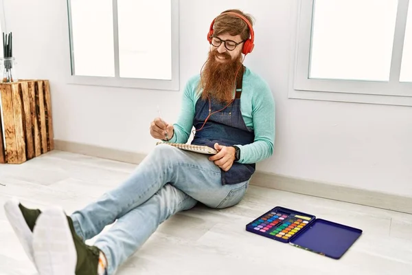 Young Redhead Man Listening Music Drawing Art Studio — Stok fotoğraf