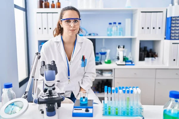 Young Hispanic Woman Working Scientist Laboratory Puffing Cheeks Funny Face — Stock Photo, Image
