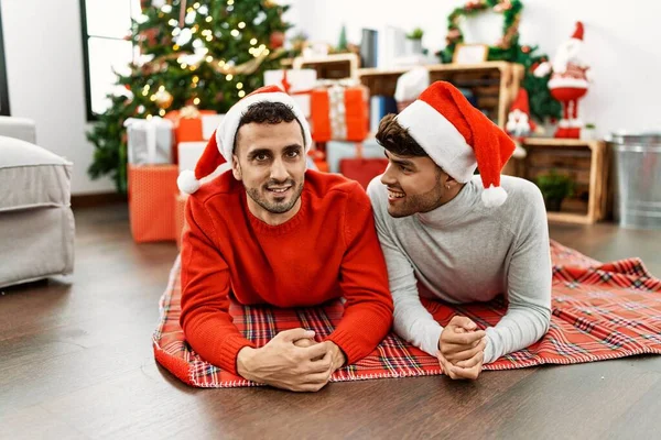Two Hispanic Men Couple Smiling Confident Lying Christmas Tree Home — ストック写真
