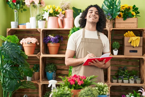 Young Latin Man Florist Smiling Confident Writing Notebook Flower Shop — Stock Photo, Image